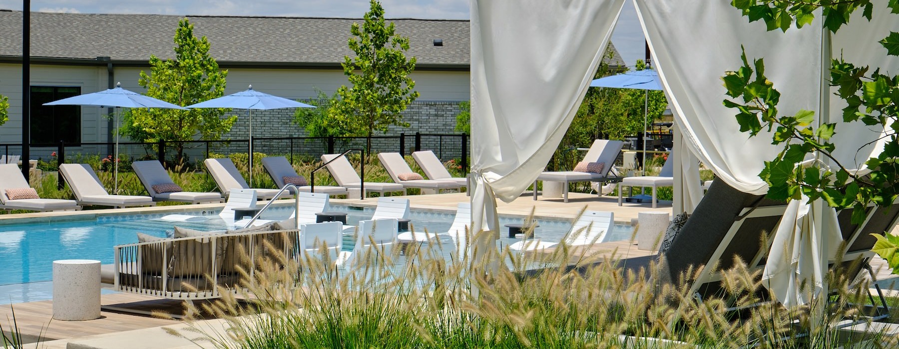 a swimming pool with lounge chairs