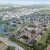 an arial view of a town with many buildings and a pond